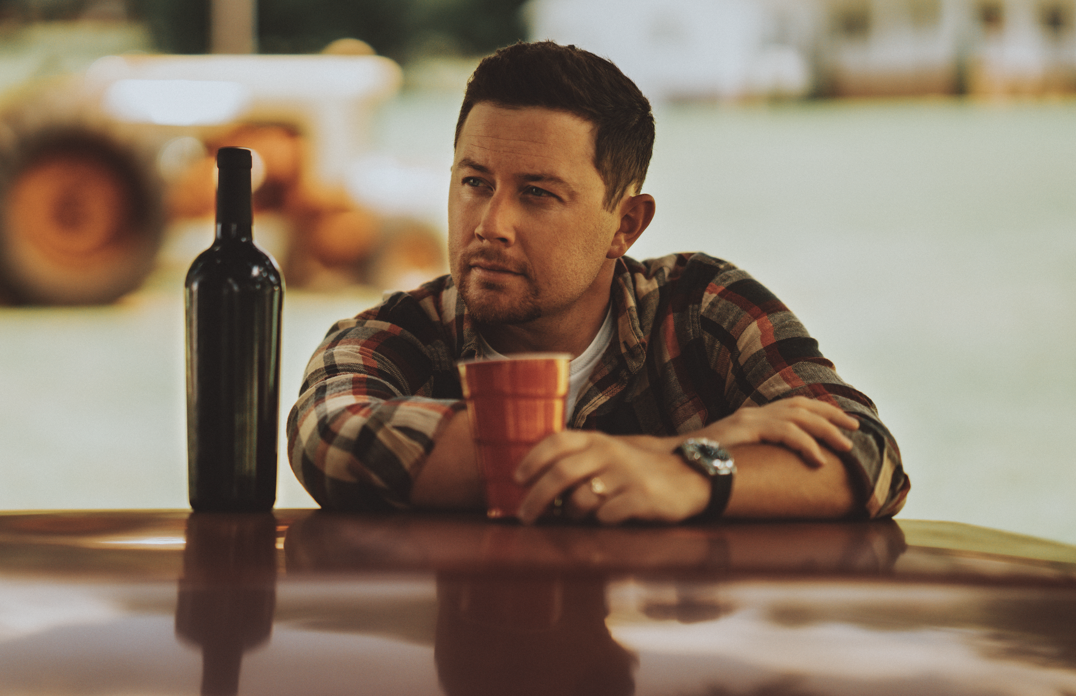 Scotty McCreery leaning on a car